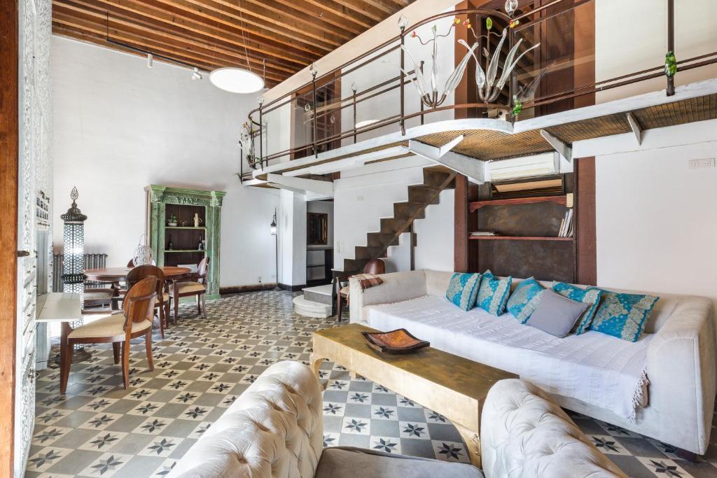 a living room with a couch and a staircase at Casa catedral in Murcia