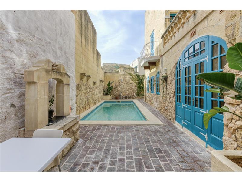 - une piscine au milieu d'un bâtiment dans l'établissement Authentic 4 Br Gozitan Farmhouse with Private Pool by 360 Estates, à L-Għarb