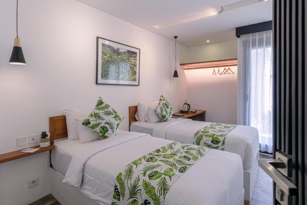 Postel nebo postele na pokoji v ubytování Chandi Hotel Ubud