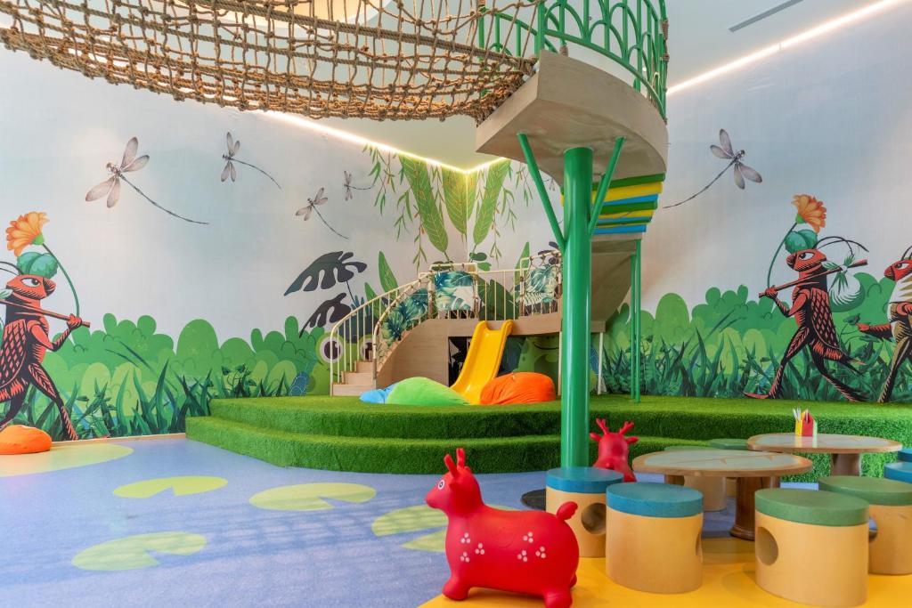 a childrens play room with a jungle mural on the wall at TTC Van Phong Bay Resort - Himalaya Sauna & Steam Retreat Included in Ninh Hòa