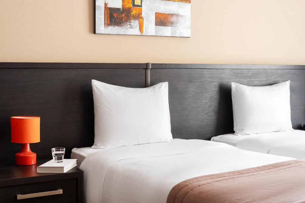 Postel nebo postele na pokoji v ubytování Sephia Hotel