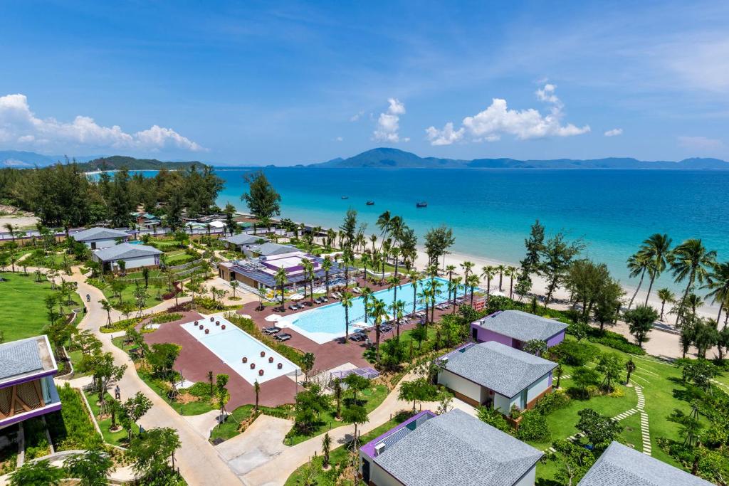 an aerial view of a resort with a pool and the ocean at TTC Van Phong Bay Resort in Ninh Hòa