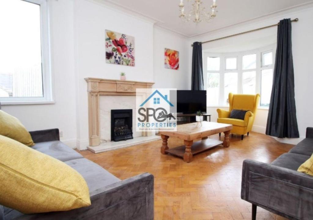 a living room with a couch and a coffee table at Spacious 4BR Home-8 Guests-Business-Families-Netflix-Free Parking & WiFi in Cardiff