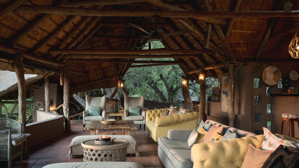 a large living room with couches and a table at Mashatu Lodge in Lentswelemoriti