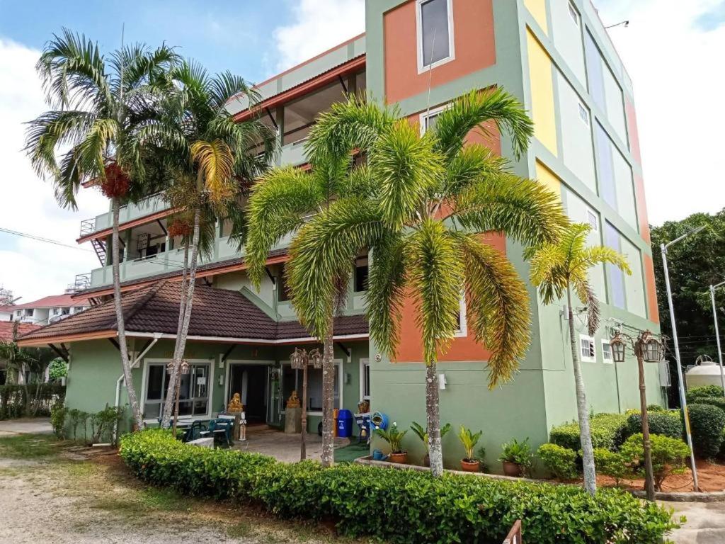 a building with palm trees in front of it at 22 Seasons Hotel in Ban Khlong Chi Lat