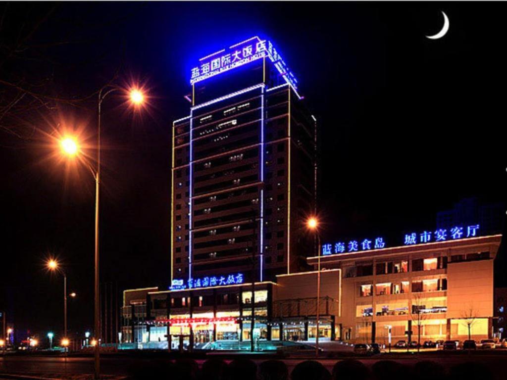 a building with blue lights on top of it at night at Zibo Blue Horizon International Hotel in Zibo