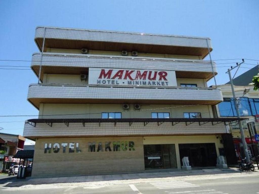 a hotel with a sign on the side of a building at Hotel Makmur in Karanganyar