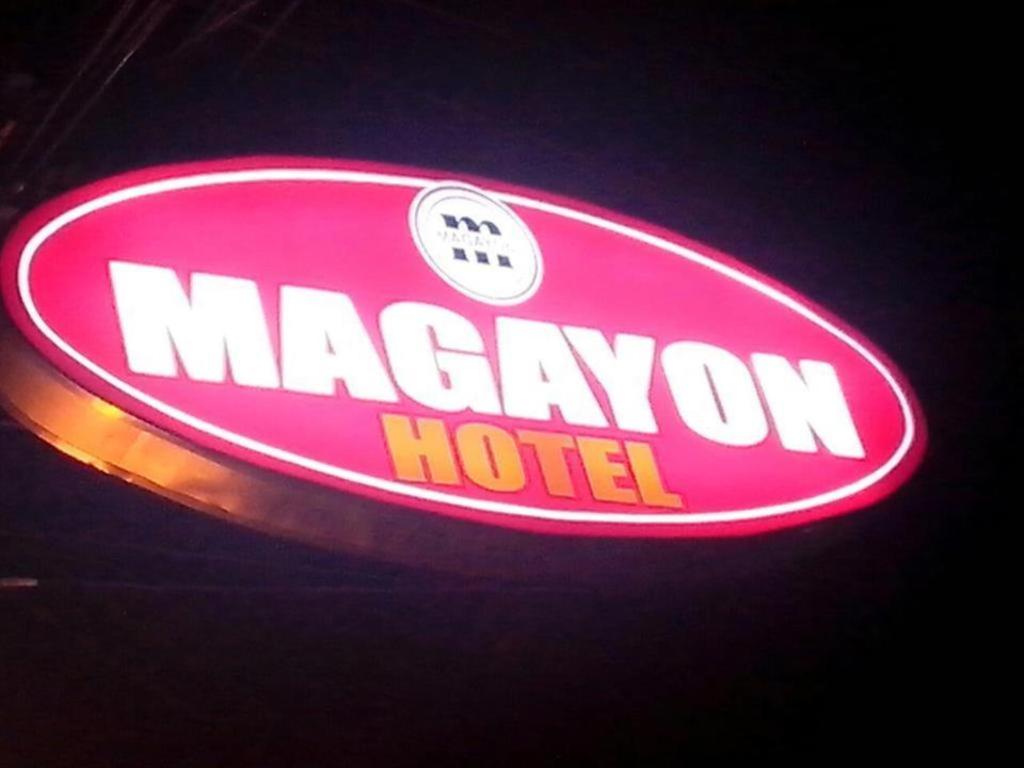 a neon sign for a macaroon hotel at Magayon Hotel in Buenavista