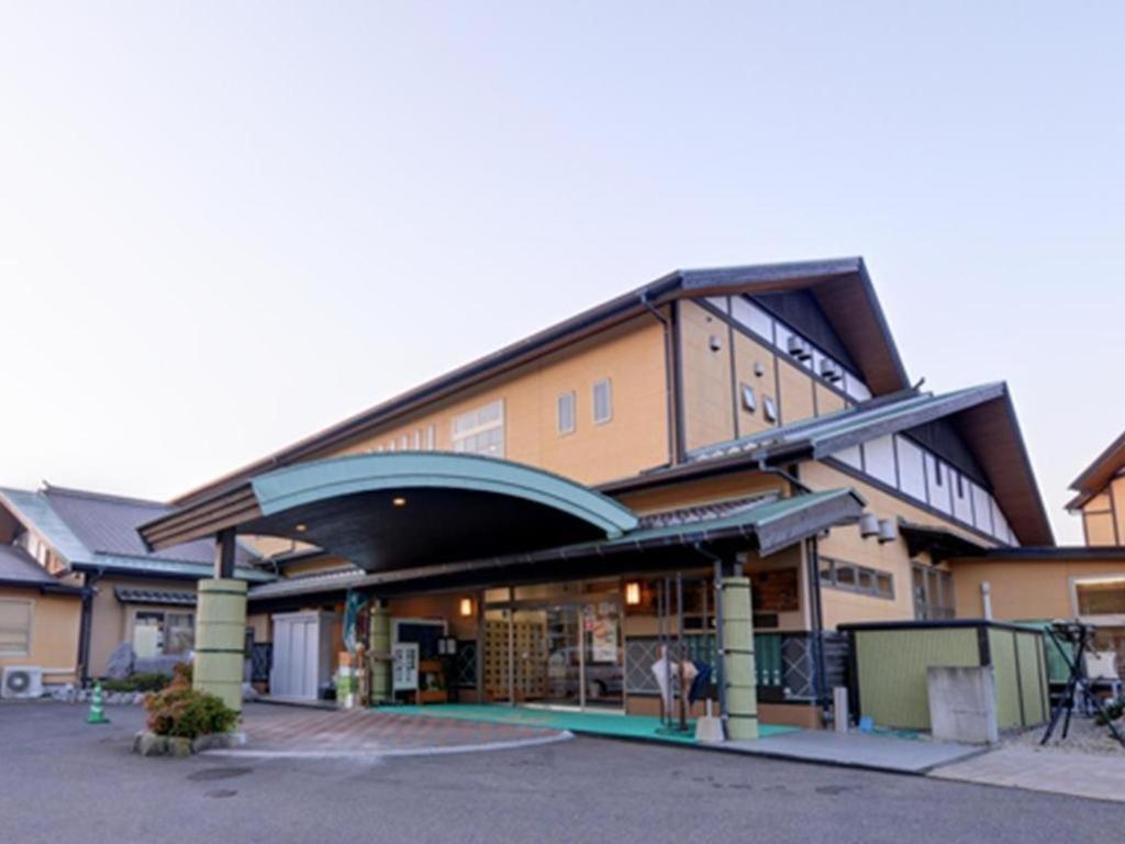 a large building with a store front with a lot at Nanaironoyu Hotel in Takeo