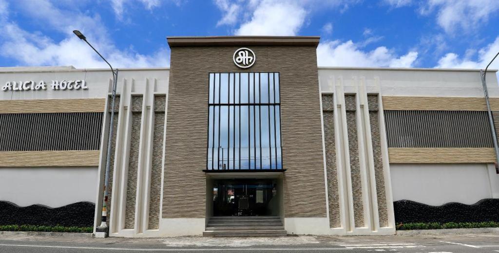 a building with a volkswagen sign on the front at Alicia Hotel & Restaurant in Legazpi