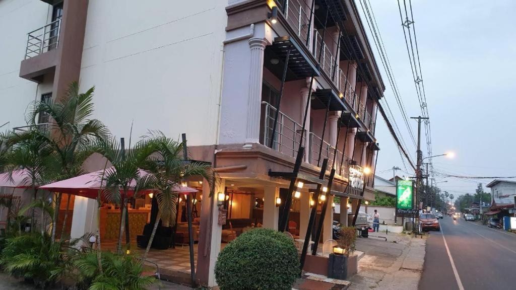 a building with a restaurant on the side of a street at Baan Rim Khong Hotel in Ban Nong Saeng