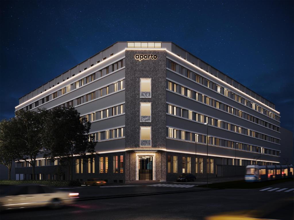 a large office building with a car in front of it at aparto Milan Ripamonti in Milan