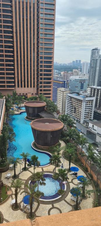 a view of a city with trees and a fountain at Raymond Apartment Times Square kuala Lumpur in Kuala Lumpur