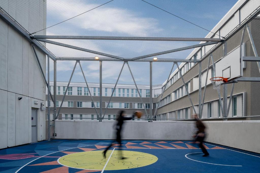 two people playing basketball on a basketball court at aparto Milan Ripamonti in Milan
