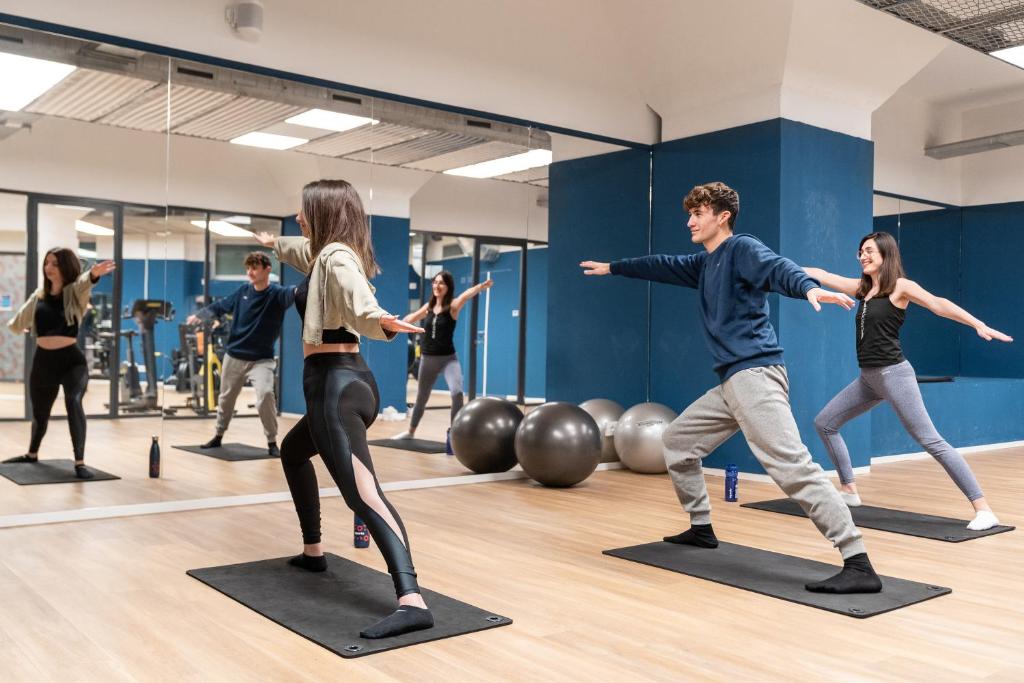 a group of people dancing in a gym at aparto Milan Ripamonti in Milan
