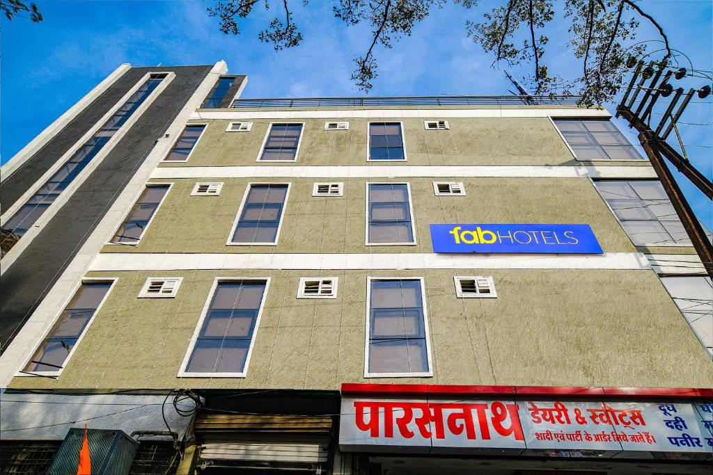 a tall building with a blue sign on it at FabHotel Blue Ocean in Indore