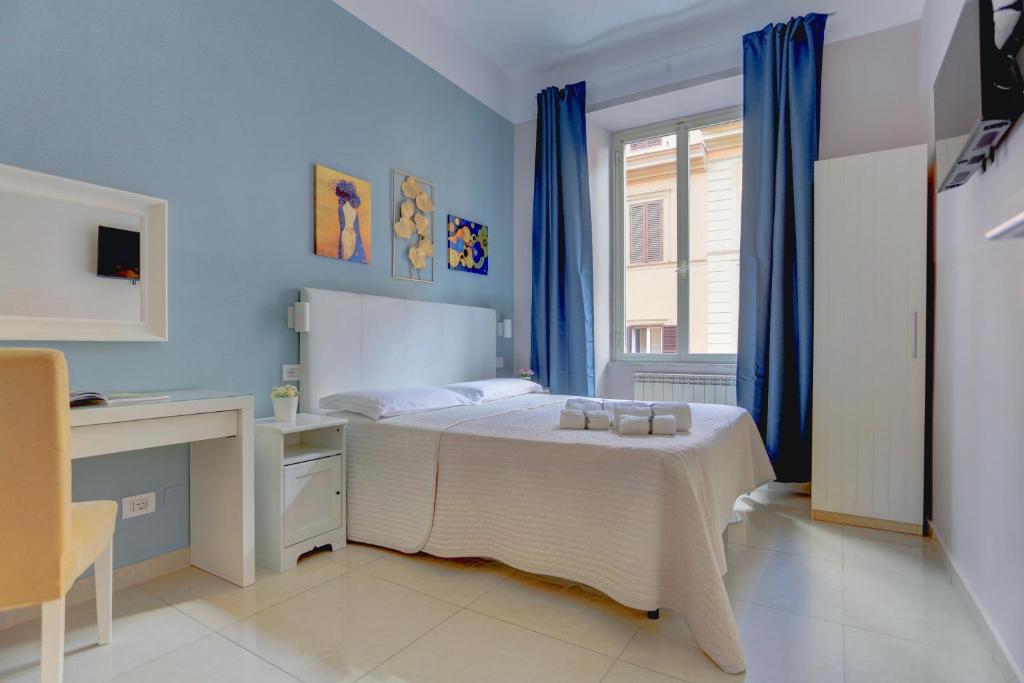 a bedroom with a bed with blue walls and a window at Happy Seasons in Rome