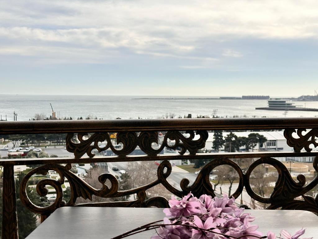 a balcony with a table and a view of the ocean at Sea view lux in Baku