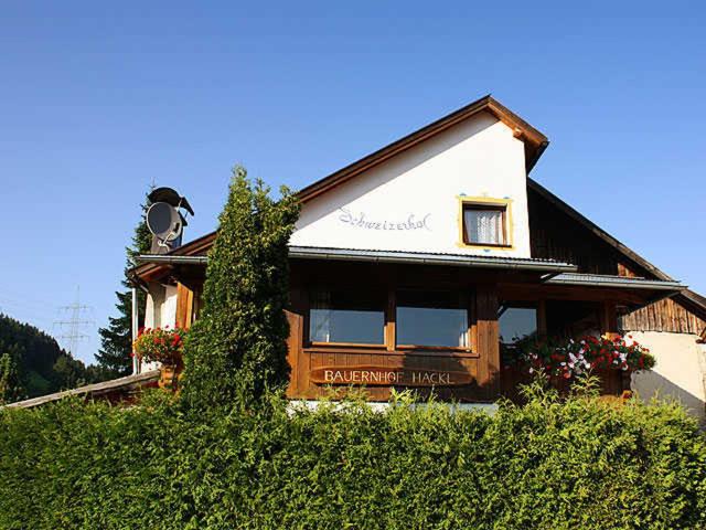 een huis op een heuvel met bloemen ervoor bij Schweizerhof 