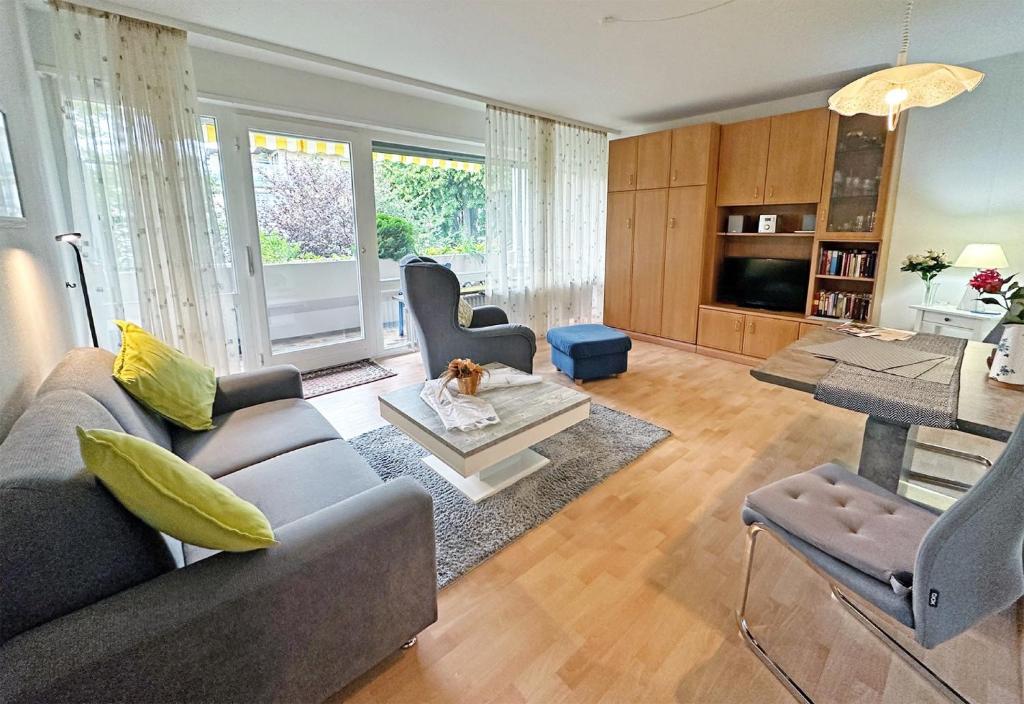 a living room with a couch and a dog sitting on a table at Apartment am Kurpark in Bad Krozingen