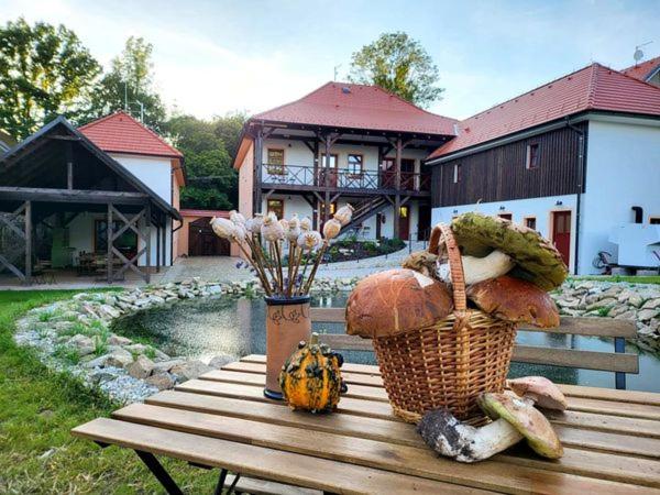 a picnic table with a bunch of vegetables on it at Apartmány Pernek in Horní Planá
