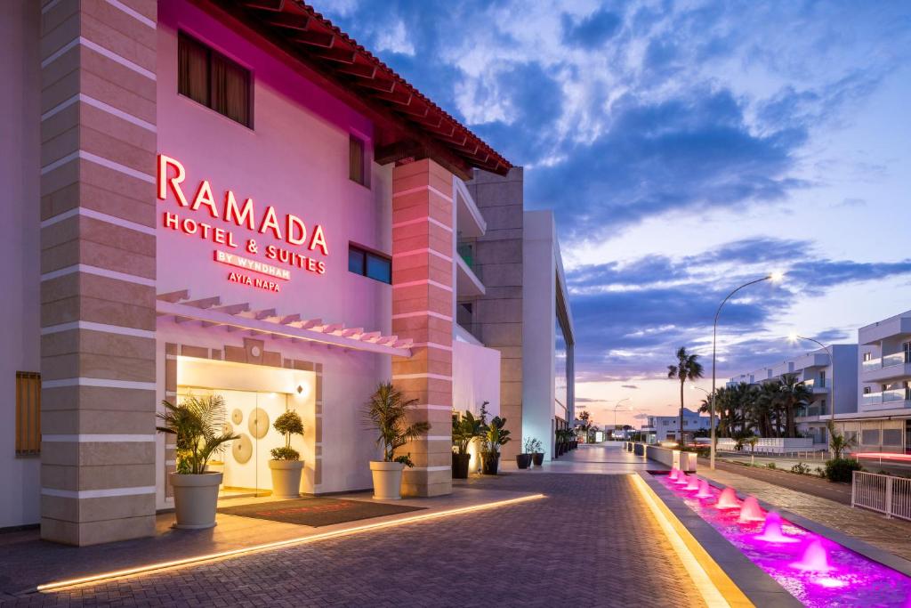 een gebouw met een bord dat ramada hotel en service leest bij Ramada Hotel & Suites by Wyndham Ayia Napa in Ayia Napa