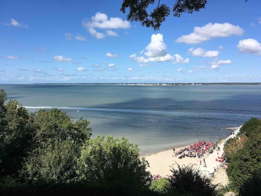 a view of a beach with people on it at Les Valéricaines Appartement Vieille Ville Saint Valery sur Somme in Saint-Valery-sur-Somme