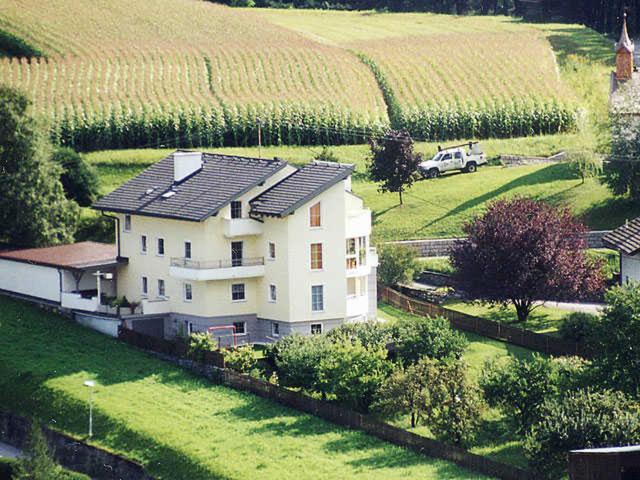 a large white house in a field of vines at Apart Sonneck in Arzl im Pitztal