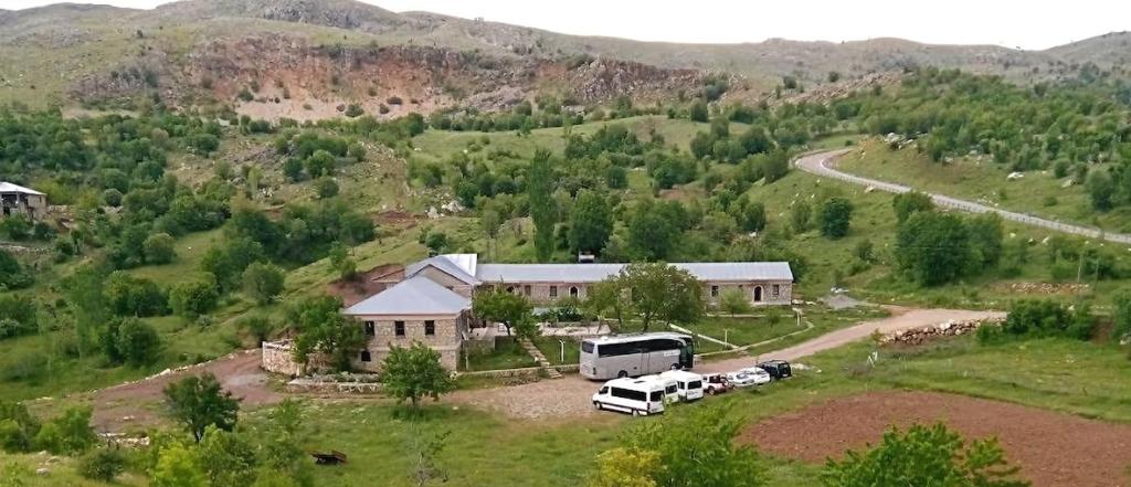 a large house with a truck parked in front of it at TARiH OTEL NEMRUT DAGI in Karadut
