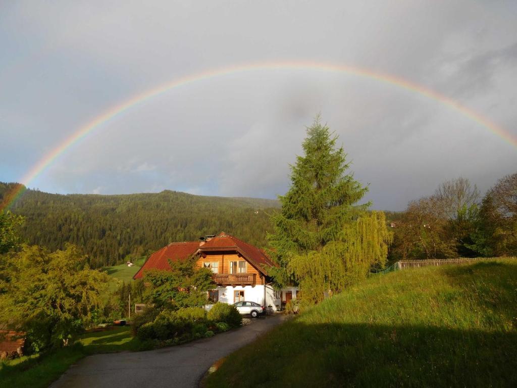 Un arcobaleno nel cielo sopra una casa di Bio - Appartements Bischof, Familie Wind ad Afritz