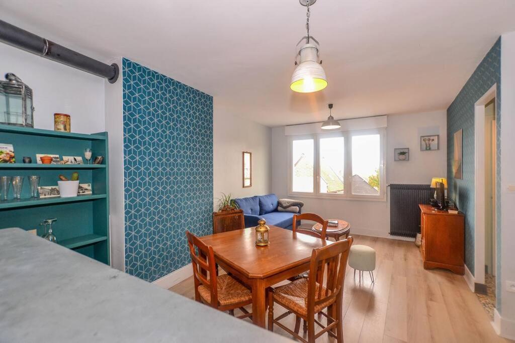 ein Wohnzimmer mit einem Tisch und einem Esszimmer in der Unterkunft Les Valéricaines - Bel appartement - vue sur les toits de St Valéry in Saint-Valery-sur-Somme