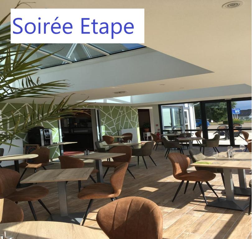 a restaurant with tables and chairs with the words surface edge at Le Pavillon de Rouen in Franqueville-Saint-Pierre