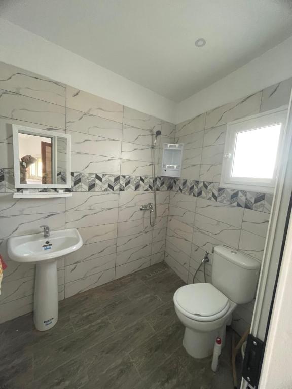 a bathroom with a toilet and a sink at Summer Rental in Nabeul