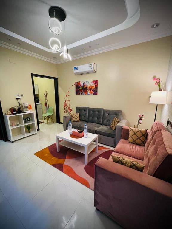 a living room with a couch and a coffee table at Abha Jacaranda in Abha