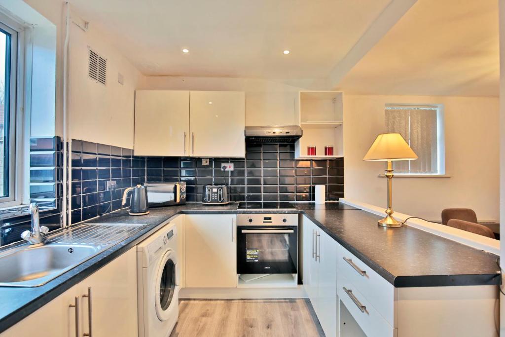 a kitchen with a sink and a dishwasher at Butlers Meadow House, Sleeps 5, near Blackpool Tower, BAE System, Free Parking - by NMB Property in Weeton