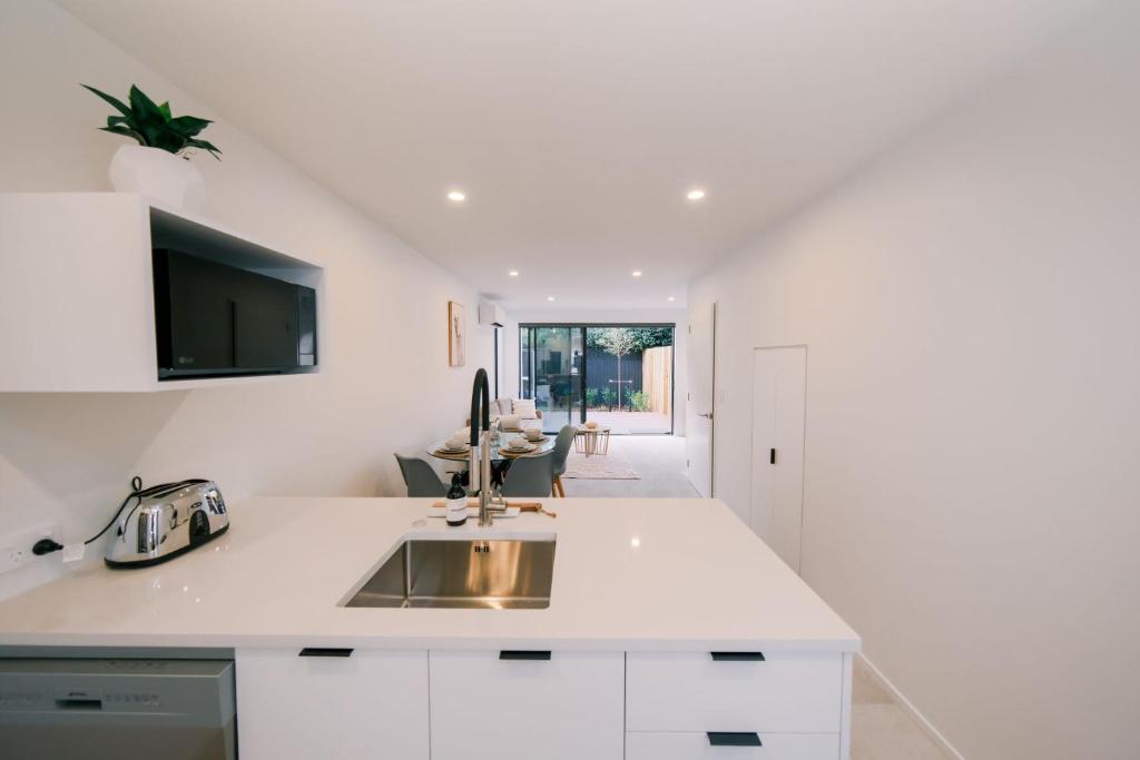 a kitchen with a sink and a counter top at Charming Retreat in the Heart of Christchurch City-CBD 