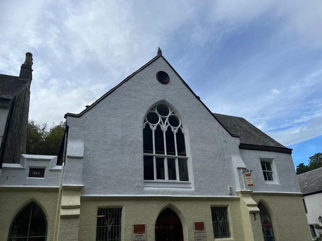a church with a large window on top of it at Lairds and Keepers Apartments in Dunkeld