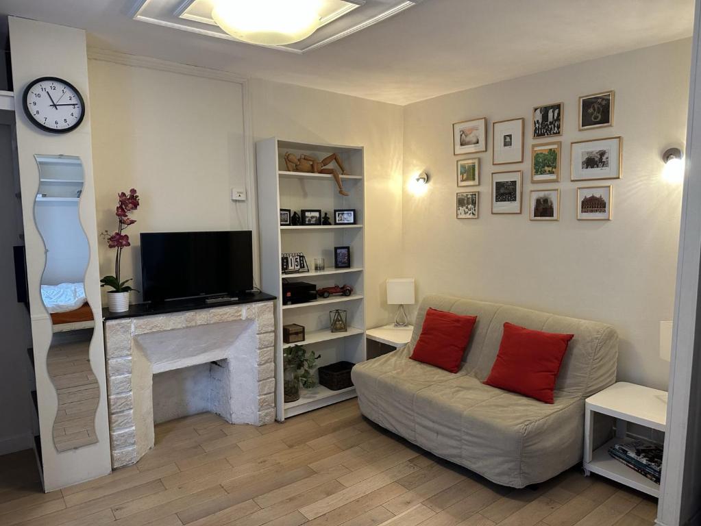 un salon avec un canapé et une cheminée dans l'établissement Heart of Paris, quiet, perfect to enjoy the city, à Paris