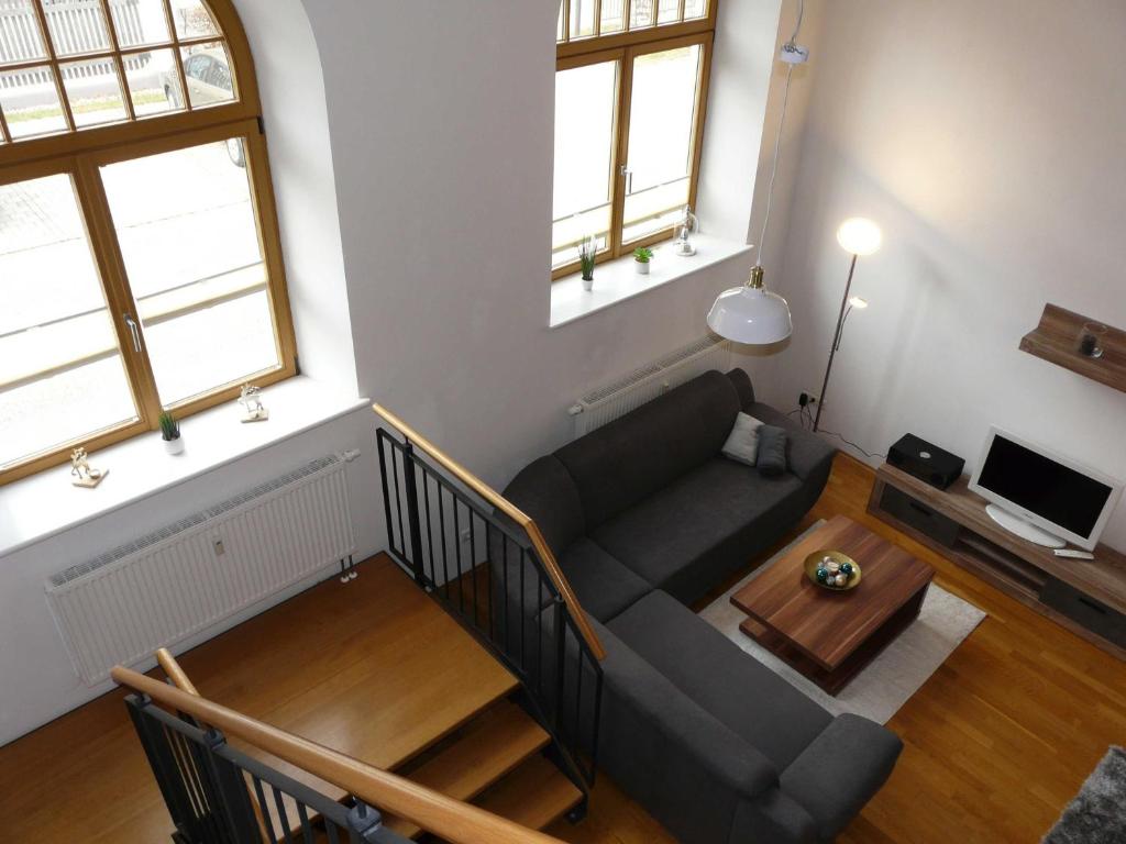 a living room with a couch and a table at Kampenwand-Loft in Aschau im Chiemgau