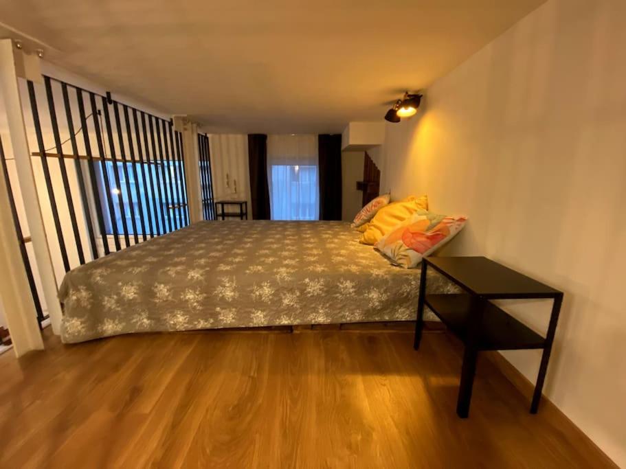 a bedroom with a bed and a table in it at Kramare 303 in Bratislava