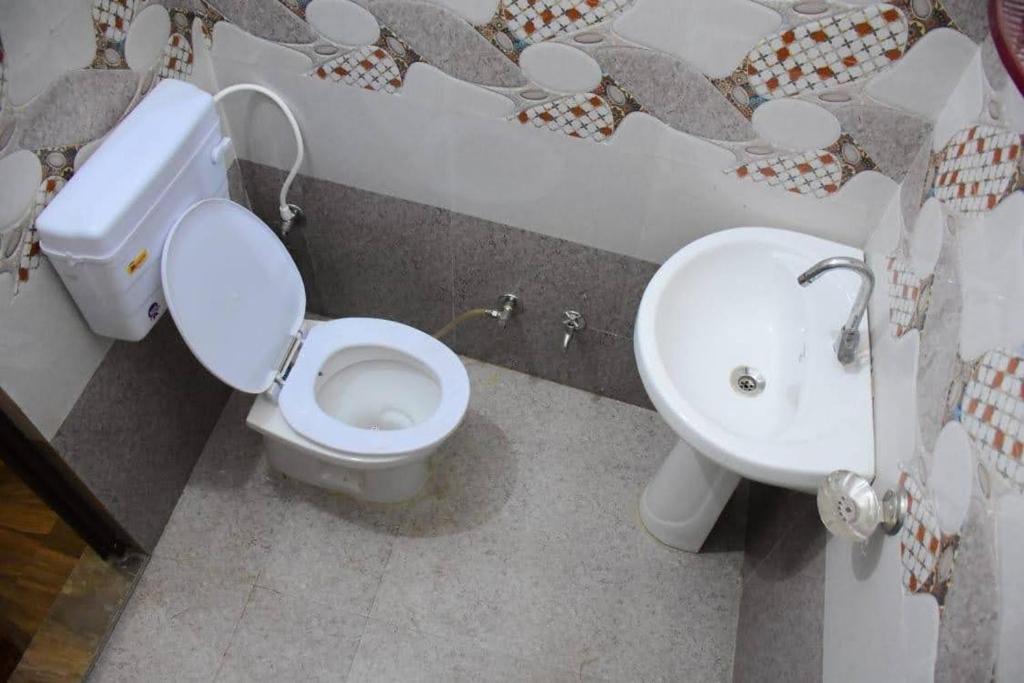 a bathroom with a toilet and a sink at Hotel diamond tree by dream homes group in Agra