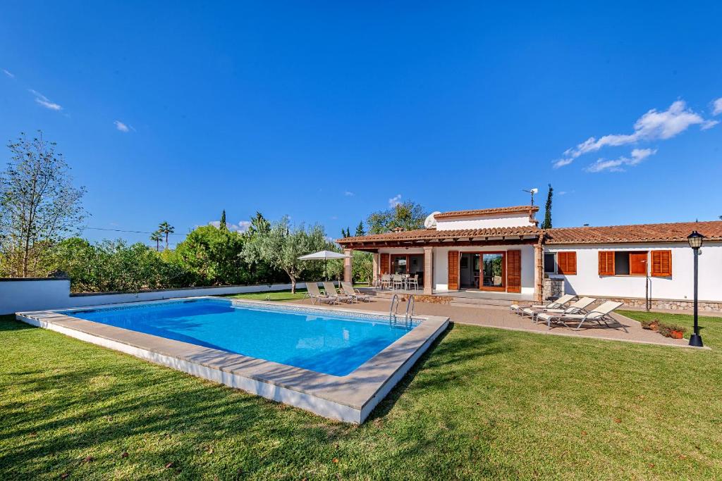 a house with a swimming pool in a yard at Beach Villa Can Carles by Sealand Villas in Port de Pollensa