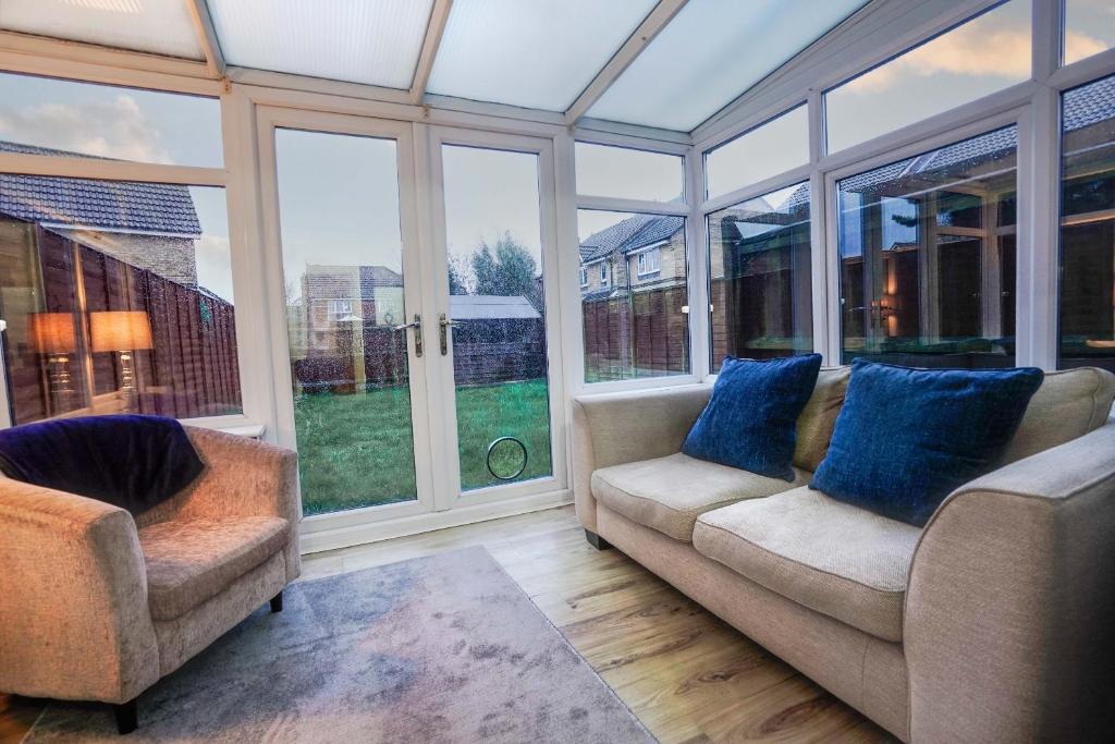 a living room with two couches and large windows at Lummis Vale in Ipswich