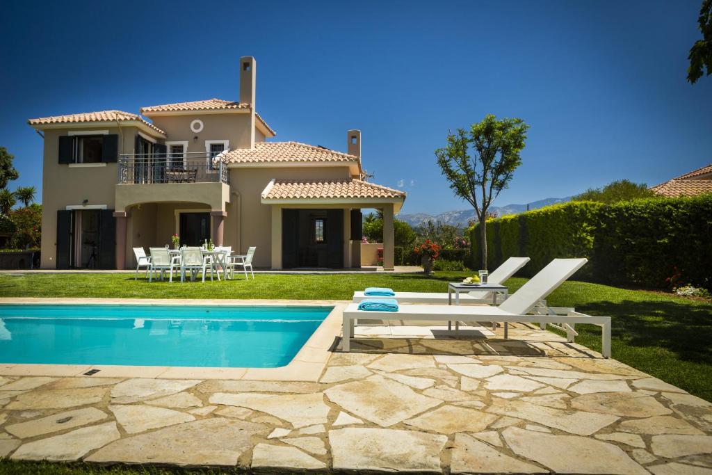 a villa with a swimming pool and a house at Villa Haris in Argostoli