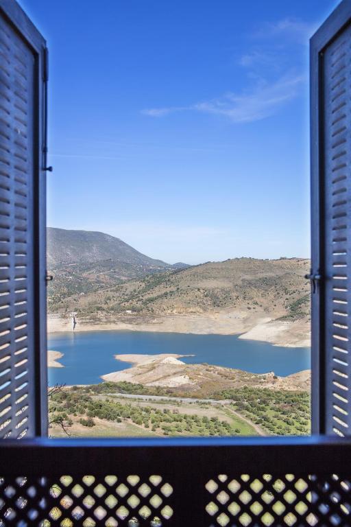 a view of a lake from a window at Hotel Tugasa Arco de la Villa in Zahara de la Sierra