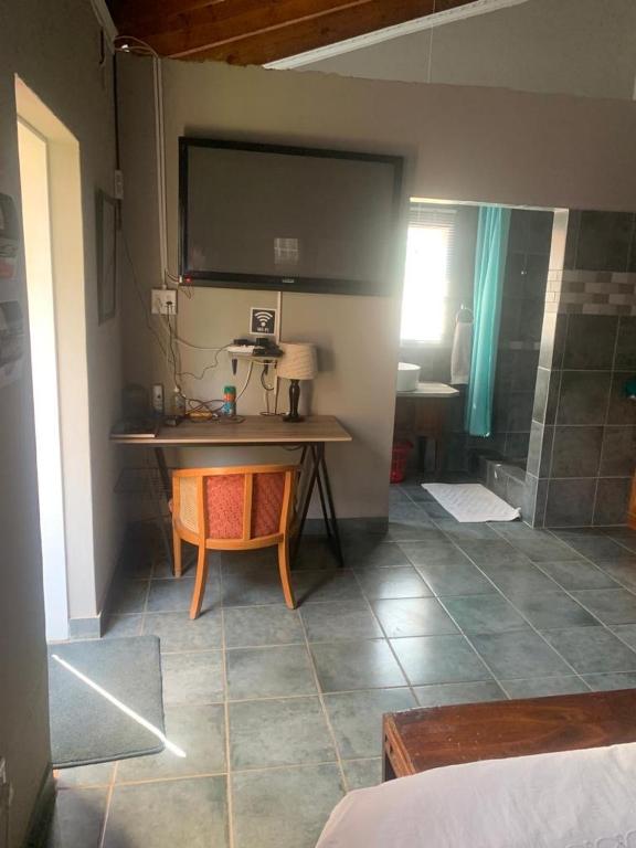 a room with a table and a screen on the wall at MAM in Mokopane
