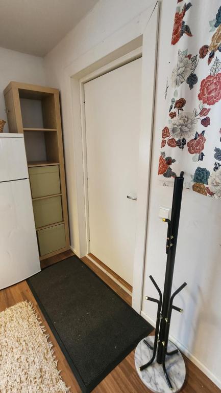 a room with a white door and a black rug at Guesthouse with Sauna in Lahti