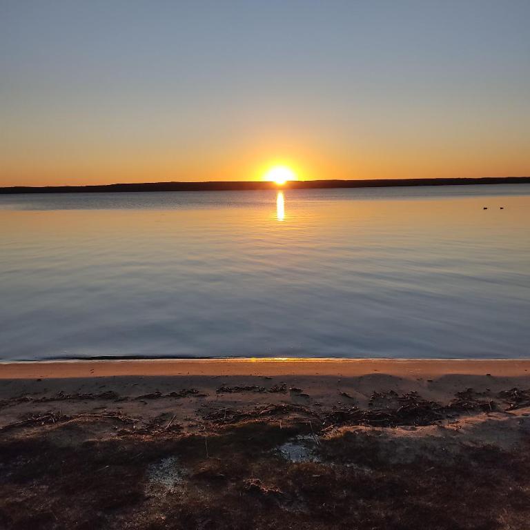 a sunset over a large body of water at Ralph's Haus am See in Plau am See