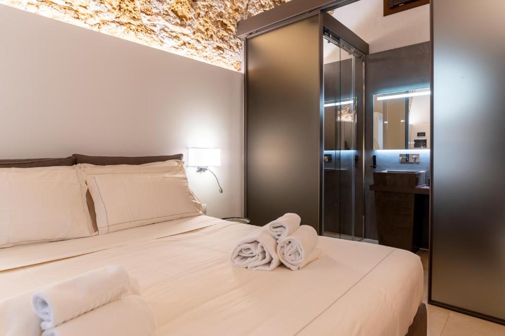 Postel nebo postele na pokoji v ubytování Bastione Spasimo Boutique Hotel