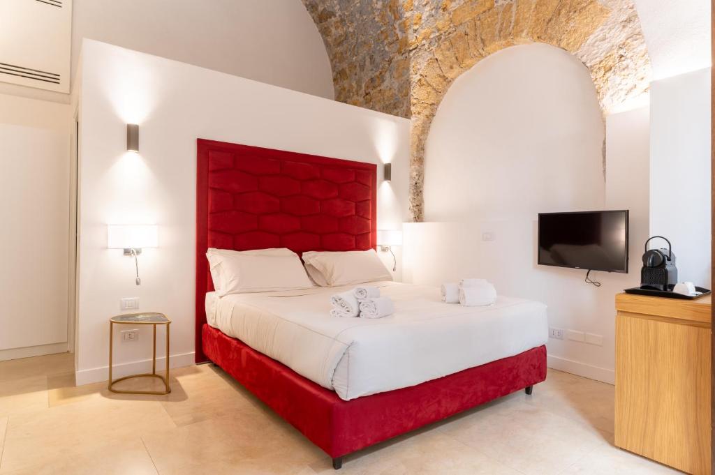 Postel nebo postele na pokoji v ubytování Bastione Spasimo Boutique Hotel